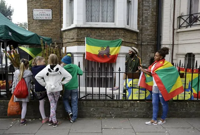 A group of children look at items for sale from a street vendor in Ladbroke Grove during the Notting Hill Carnival in London, Britain, August 30, 2015. (Photo by Kevin Coombs/Reuters)