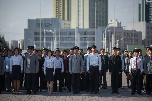 Spectators gather to watch a television news brodcast of a statement delivered by North Korean leader Kim Jong- Un, before a public television screen outside the central railway station in Pyongyang on September 22, 2017. (Photo by Ed Jones/AFP Photo)