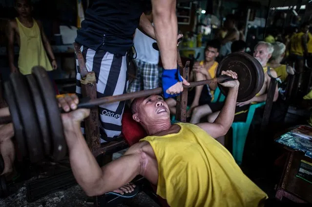 An inmate lifts weights at a gym inside the Quezon City Jail in Manila in this picture taken on July 18, 2016. (Photo by Noel Celis/AFP Photo)