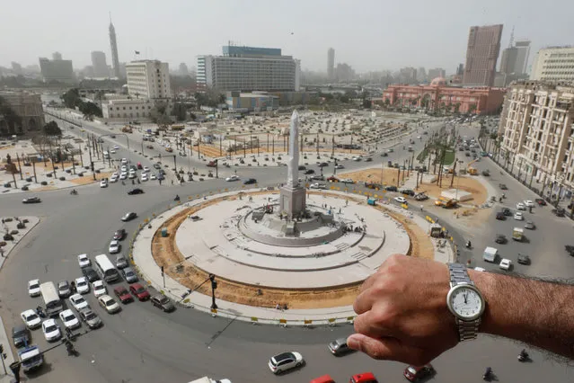 A watch showing the time at noon, is displayed for a photo in front of Tahrir Square during the coronavirus disease (COVID-19) outbreak, in Cairo, Egypt, March 31, 2020. (Photo by Mohamed Abd El Ghany/Reuters)