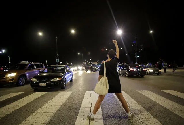 A demonstrator raises her fist as she blocks Lake Shore Drive during a protest for the fatal police shooting of Paul O'Neal August 7, 2016 in Chicago, Illinois. O'Neal, an unarmed 18-year-old man  was shot and fatally wounded July 28, when Chicago Police officers tried to arrest him for allegedly stealing a Jaguar car from the suburbs. The Chicago Police department released videos of the shooting to the public and media, which was captured by body cameras and dashboard cameras. (Photo by Joshua Lott/Getty Images)