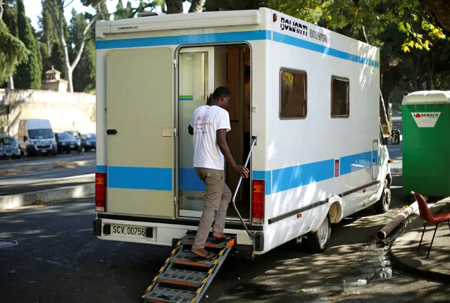 A migrant enters a Vatican sanitary vehicle, run by volunteers, at a makeshift camp in Via Cupa (Gloomy Street) in downtown Rome, Italy, August 1, 2016. (Photo by Max Rossi/Reuters)