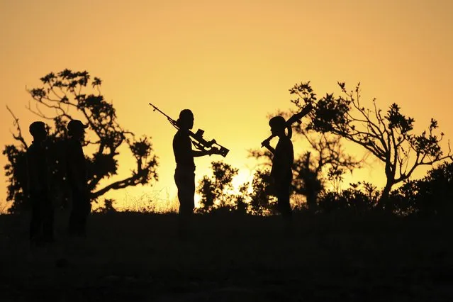 Free Syrian Army fighters carry their weapons on one of the frontlines of Wadi Al-Dayf camp in the southern Idlib countryside September 5, 2014. (Photo by Khalil Ashawi/Reuters)