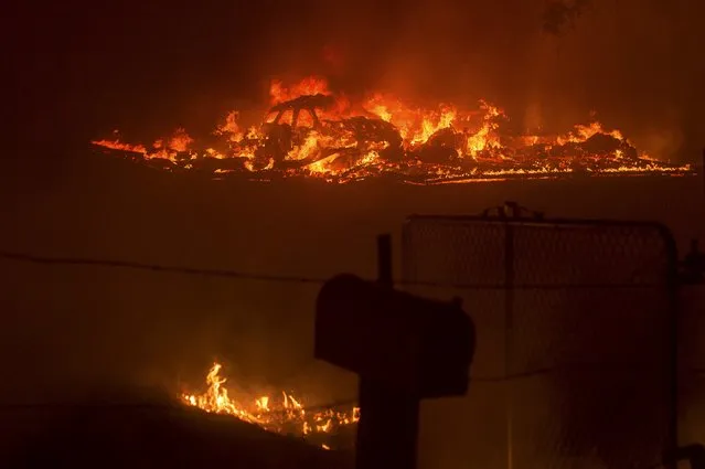 A car burns as the Butte fire rages through Mountain Ranch, California September 11, 2015. (Photo by Noah Berger/Reuters)