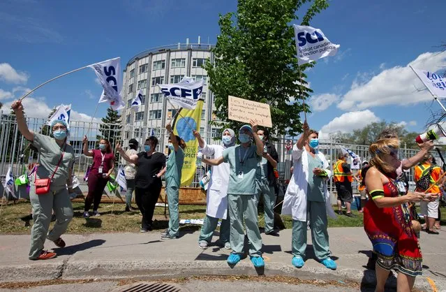 Health care workers, professionals and unions demanding safer working conditions and time off amid the coronavirus disease (COVID-19) outbreak, protest in front of Santa Cabrini Hospital in Montreal, Quebec, Canada on May 29, 2020. (Photo by Christinne Muschi/Reuters)