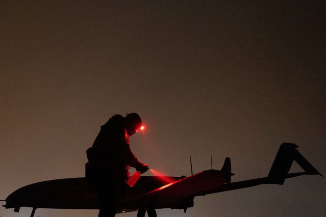 A Ukrainian service member of the 14th Unmanned Aerial Systems Regiment prepares a deep strike unmanned aerial vehicle before its launch toward Russian territory, in an undisclosed location in Ukraine on January 24, 2025. (Photo by Valentyn Ogirenko/Reuters)