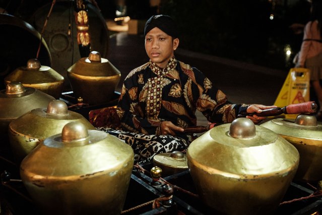 A member of Yogyakarta's Wayang Kulit (shadow puppet) theatre group Sanggar Widya Pramana plays local instruments called Gamelan during a performance of the Hindu heroic tale Ramayana at The Local Market, organised by non-profit Kuka Indonesia which supports education for underprivileged communities, in Jakarta on February 9, 2025. (Photo by Yasuyoshi Chiba/AFP Photo)