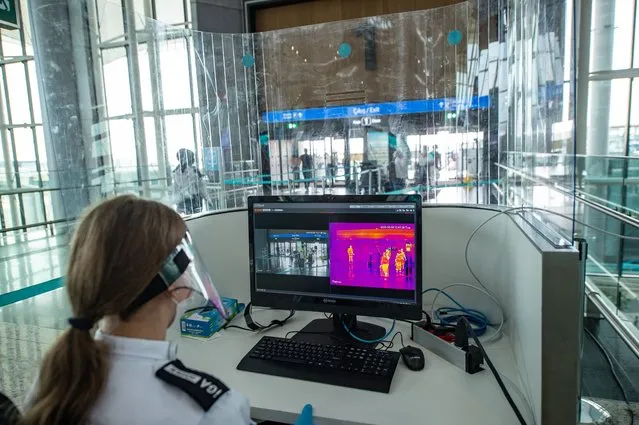 A security officer looks at a scanning screen for checking passengers' temperature at the Istanbul Airport in Istanbul, Turkey, on June 9, 2020. Technology and innovation will top the precautions of Turkey's biggest airport Istanbul Airport against the COVID-19 in the post-pandemic era, according to the management of the airport. The management on June 9 presented their final preparations and measures taken against coronavirus while Turkish airline companies are preparing to resume their international operations the next day. (Photo by Yasin Akgul/Xinhua News Agency via Getty Images)