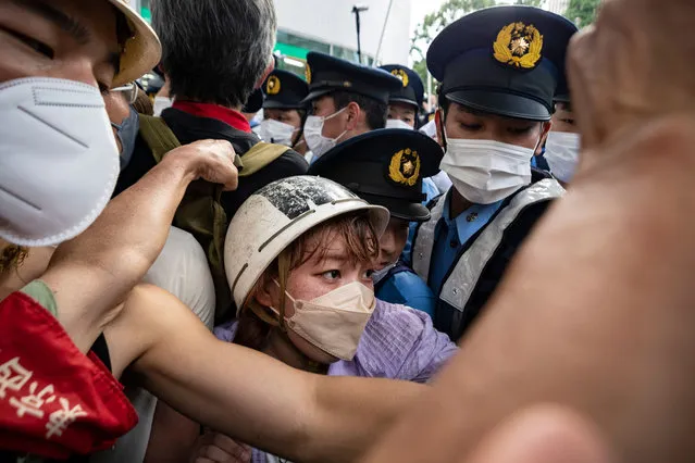 A female activist scuffles with police during a demonstration against the state funeral near the funerals venue in Tokyo, Japan on Sepember 27, 2022 (Photo by Yusuke Harada/NurPhoto via Getty Images)