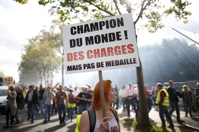 French non-union self-employed workers attend a demonstration against the RSI (social security for independent workers) in Paris, France, September 21, 2015. The placard reads “World champion for taxes, but no medal”. (Photo by Charles Platiau/Reuters)