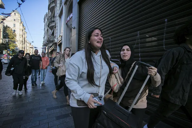People leave the area after an explosion on Istanbul's popular pedestrian Istiklal Avenue Sunday, Istanbul, Sunday, November 13, 2022. (Photo by Can Ozer/AP Photo)