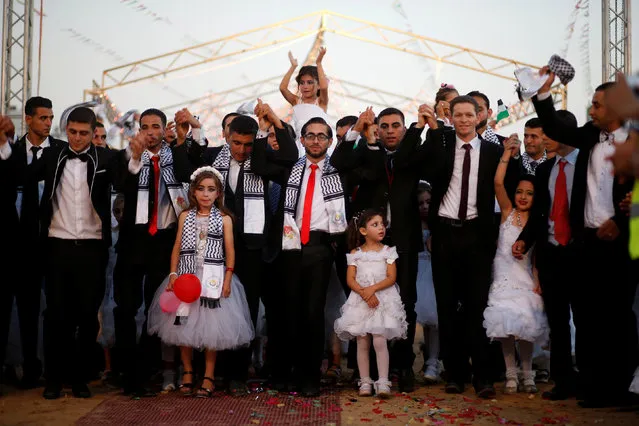 Girls accompany grooms during a mass wedding for 340 couples organized by Hamas movement in Beit Lahiya town in the northern Gaza Strip July 24, 2016. (Photo by Mohammed Salem/Reuters)