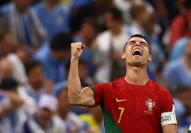 Cristiano Ronaldo #7 of Portugal celebrates his team's first goal by team mate Bruno Fernandes #8 during the FIFA World Cup Qatar 2022 Group H match between Portugal v Uruguay at Al Janoub Stadium on November 28, 2022 in Lusail City, Qatar. (Photo by Kai Pfaffenbach/Reuters)