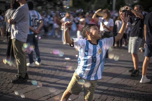 A boy chases bubbles as he celebrates Argentina's victory in the World Cup in Buenos Aires, Argentina, Dic. 03, 2022. The Argentine soccer team won their match against Australia and advances to the next round of the soccer world cup. Argentines go out to celebrate in the streets of Buenos Aires. (Photo by Pablo Barrera/Anadolu Agency via Getty Images)