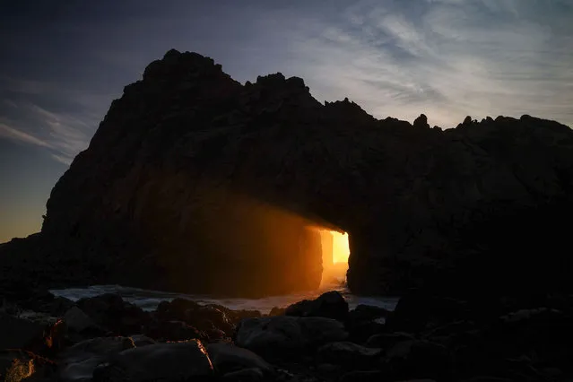 A sunray passes through Keyhole Arch during sunset at Pfeiffer Beach in Big Sur, California, United States on December 24, 2022. (Photo by Tayfun Coskun/Anadolu Agency via Getty Images)
