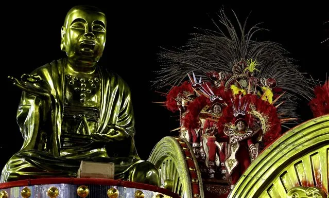 Dancers perform atop a float during the Inocentes de Belford Roxo samba school parade at the Sambadrome in Rio de Janeiro. (Photo by Hassan Ammar/Associated Press)