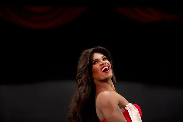 In this October 18, 2015 photo, contestant Alfredo Lopez, Miss Gay Miranda, competes at the ninth annual Miss Gay Venezuela beauty pageant in Caracas, Venezuela. Some of the contestant's evening gowns are from Venezuela's top designers who also work with the Miss Venezuela organization. (Photo by Ariana Cubillos/AP Photo)