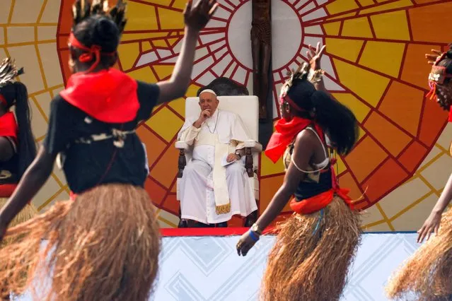 Pope Francis watches a performance as he attends a meeting with young people and catechists at the Stade des Martyrs during his apostolic journey, in Kinshasa, Democratic Republic of Congo on February 2, 2023. (Photo by Luc Gnago/Reuters)