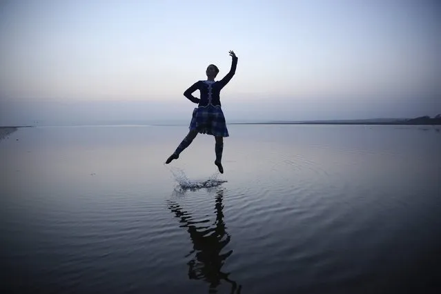 Scottish country dancer Mairie McGillivray, 16, dances on the beach at Bridgend as she poses for a photograph on the Hebridean island of Islay, in this March 11, 2014 file photo. (Photo by Paul Hackett/Reuters)