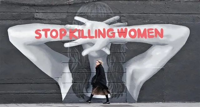 A woman on Wednesday, January 4, 2023 walks past a mural painted for Women's Aid by the artist Emmalene Blake in Dublin, following a spate of recent killings of women in Ireland. (Photo by Niall Carson/The Irish Times)