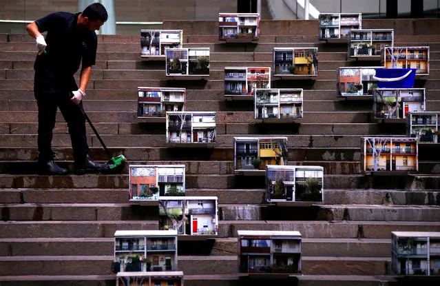 A cleaner washes the steps of a building where photographs of terrace houses are displayed in central Sydney, Australia, October 3, 2016. (Photo by David Gray/Reuters)