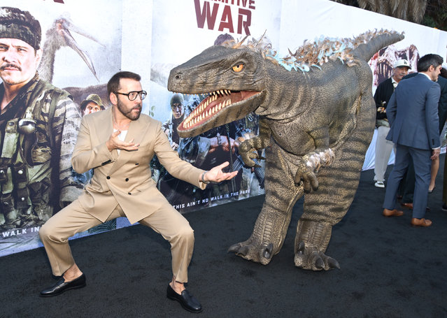 Actor Jeremy Piven (L) faces off against a dinosaur during the Los Angeles premiere of “Primitive War” at Hollywood American Legion on August 18, 2025 in Los Angeles, California. (Photo by Michael Tullberg/Getty Images)