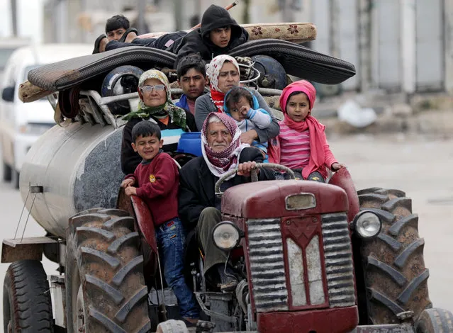 People flee after Turkish-backed Free Syrian Army fighters captured Khaldieh village in eastern Afrin, Syria March 10, 2018. (Photo by Khalil Ashawi/Reuters)