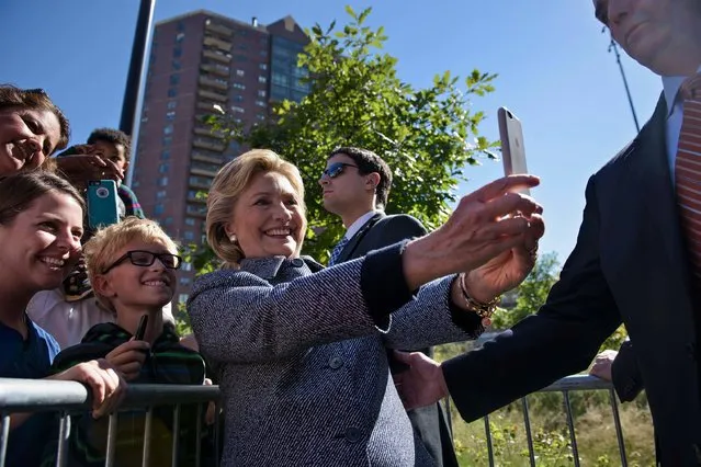 Democratic presidential nominee Hillary Clinton takes a selfie with supporters after speaking during an Iowa Democratic party early vote rally September 29, 2016 in Des Moines, Iowa. (Photo by Brendan Smialowski/AFP Photo)