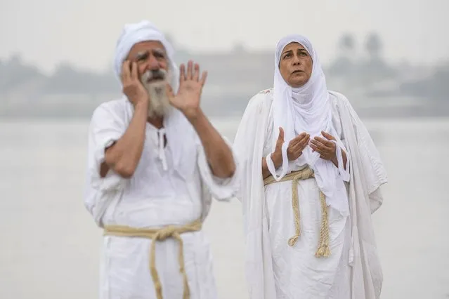 Followers of the Sabean Mandaeans faith, a pre-Christian sect that follows the teachings of the New Testament's  John the Baptist, perform their rituals in the Tigris River during a celebration marking “Banja” or Creation Feast, in central Baghdad, Iraq, Tuesday, March 14, 2023. Iraqi Sabaean Mandeans view John the Baptist as its central prophet and submerge themselves in the Tigris during an annual five-day ritual. (Photo by Hadi Mizban/AP Photo)