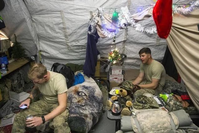 U.S. soldiers from the 3rd Cavalry Regiment relax in their quarters after taking part in a mortar exercise on forward operating base Gamberi in the Laghman province of Afghanistan December 24, 2014. (Photo by Lucas Jackson/Reuters)