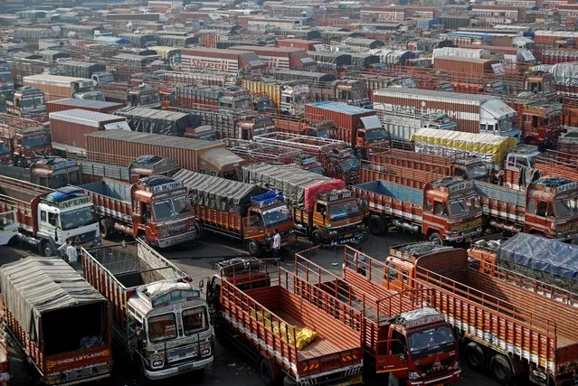 Trucks are parked at a terminal next to a wholesale vegetable market during a nationwide strike to protest against newly passed farm bills in Mumbai, India, December 8, 2020. (Photo by Francis Mascarenhas/Reuters)