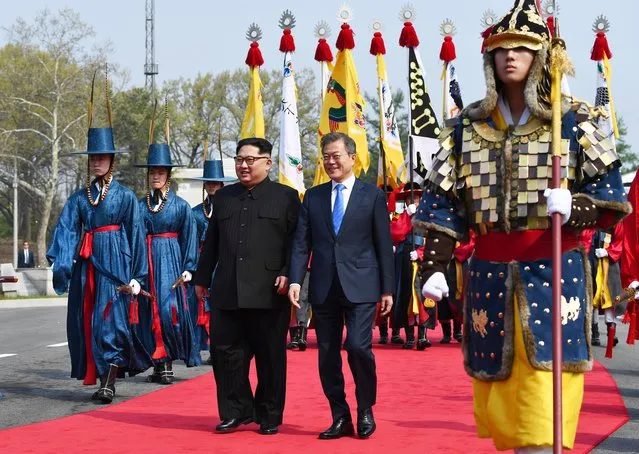 North Korean leader Kim Jong Un, left, and South Korean President Moon Jae-in walk together at the border village of Panmunjom in the Demilitarized Zone Friday, April 27, 2018. Kim made history Friday by crossing over the world's most heavily armed border to greet his rival, Moon, for talks on North Korea's nuclear weapons. (Photo by Korea Summit Press Pool via AP Photo)