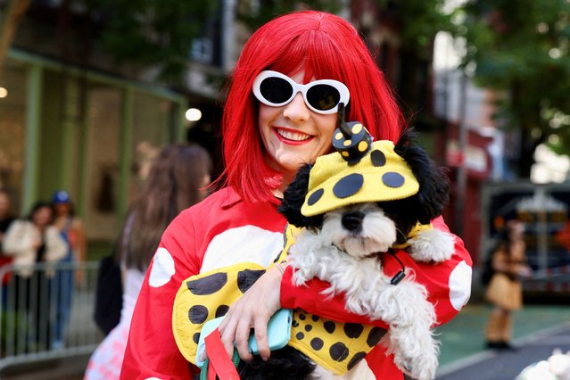Meredith and her dog Jo take part in the Annual Tompkins Square Halloween Dog Parade in New York City, U.S., October 19, 2025. (Photo by Kevin Coombs/Reuters)