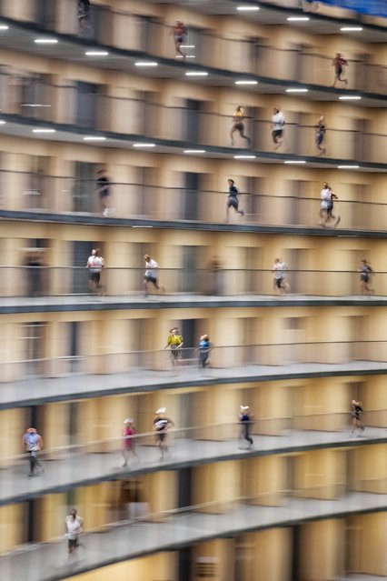 Competitors take part in the Vortex race near Lausanne, on October 16, 2025. Around 2,000 participants, mostly students take part in this unique race created in 2021 by a group of students, involving running up the 2.8 km helicoidal passageway of the Vortex, an iconic eight floor circular building of the campus of the University of Lausanne. (Photo by Fabrice Coffrini/AFP Photo)