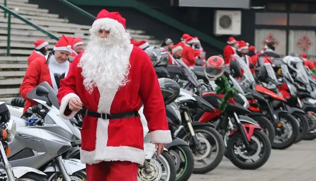 Motorcycle riders wearing Santa Claus costumes are seen on their motorbikes as they distribute new year gifts to children in Novi Sad, Serbia on December 27, 2020. (Photo by Aleksandar Jovanovic/Anadolu Agency via Getty Images)