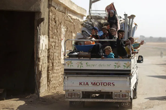 Internally displaced refugees that fled violence ride a pick-up truck in al-Kherbeh village, northern Aleppo province, Syria October 24, 2016. (Photo by Khalil Ashawi/Reuters)