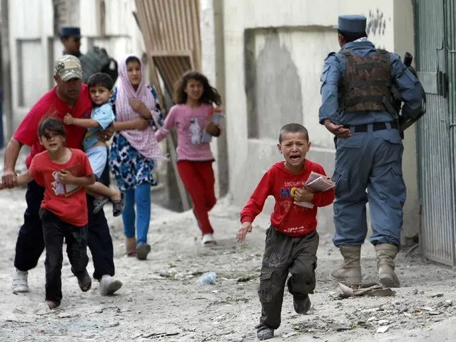 Children run away after an explosion in Kabul May 24, 2013. Several large explosions rocked a busy area in the centre of the Afghan capital, Kabul, on Friday with Reuters witnesses describing shooting in the area.(Photo by Omar Sobhani/Reuters)