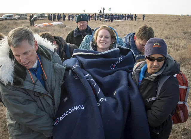 In this photo released by NASA, NASA astronaut Kate Rubins is carried to a medical tent after she is helped out of the Soyuz MS-01 spacecraft along with Russian cosmonaut Anatoly Ivanishin of Roscosmos and astronaut Takuya Onishi of the Japan Aerospace Exploration Agency (JAXA) who landed in a remote area near the town of Zhezkazgan, Kazakhstan Sunday, October 30, 2016. (Photo by Bill Ingalls/NASA via AP Photo)