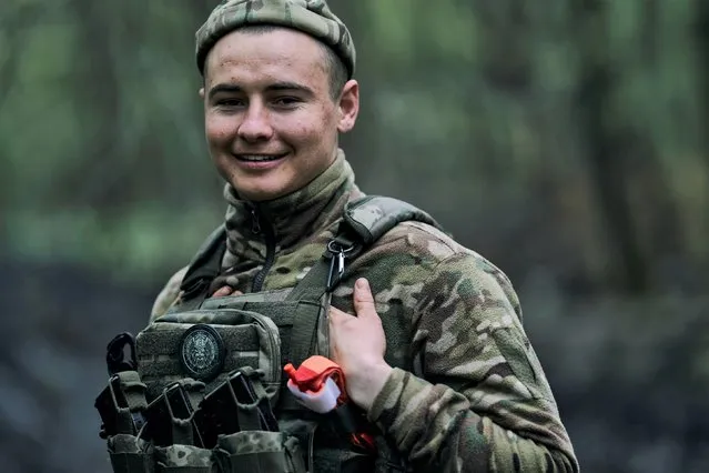 A Ukrainian soldier smiles on the frontline in Bakhmut, Donetsk region, Ukraine, Sunday, April 23, 2023. (Photo by Libkos/AP Photo)