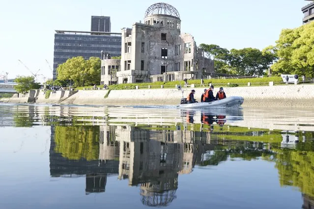 Police officers patrol on the river near the famed Atomic Bomb Dome as Japan's police beef up security ahead of the Group of Seven nations' meetings in Hiroshima, western Japan, Wednesday, May 17, 2023. (Photo by Eugene Hoshiko/AP Photo)