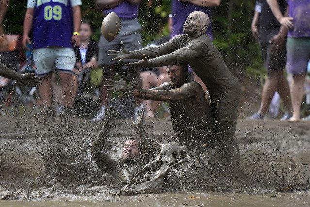 Eric Germelli, bottom, and Kevin Terban, of the Mudsharks, defend against Josh Phillips, of the Muddas, on a pass in a football game at the Mud Bowl in North Conway, N.H., Sunday, September 8, 2024. (Photo by Robert F. Bukaty/AP Photo)