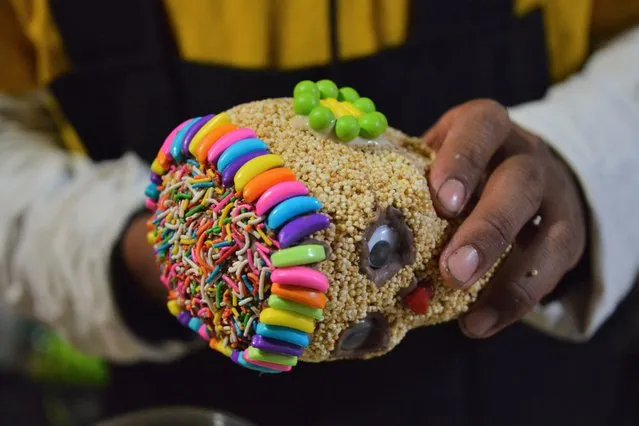 A worker decorates an amaranth skull during the manufacture to offer to customers during Dia de Muertos celebrations in Mexico City, Mexico on October 10, 2020. The Candy Factory “Dulceria Juanita”, who have been dedicated to the production of sweets for more than 30 years, have been affected due to low sales due to the new Covid-19 pandemic. Their production of sweet, amaranth and tamarind skulls has reduced to 70 percent, manufacturing only a thousand skulls due to the fact that they have not been sold due to the crisis caused by the Coronavirus pandemic, in previous years the production of amaranth skulls exceeded the 10 thousand pieces. (Photo by Carlos Tischler/Eyepix Group/Pacific Press/Rex Features/Shutterstock)