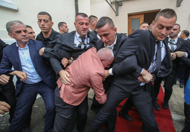 Albanian Parliament bodyguards try to stop Ramadan Lika (center) member of Parliament with opposition Democratic Party of Albania, as he trie to enter the parliament session to disrupt during a protest against the imprisonment of a fellow member of Parliament in Tirana on October 3, 2024. (Photo by Armando Babani/ZUMA Press Wire/Rex Features/Shutterstock)