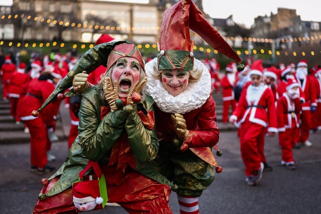 Members of the public dressed in Santa Suits take part in a fun run in Princess Street gardens on December 08, 2024 in Edinburgh, Scotland. The annual Santa Run in Edinburgh is celebrating its 20th anniversary. The charity event that sees participants dressed as Santa Claus dash through Edinburgh raises funds to grant wishes for children with life threatening illnesses. (Photo by Jeff J Mitchell/Getty Images)