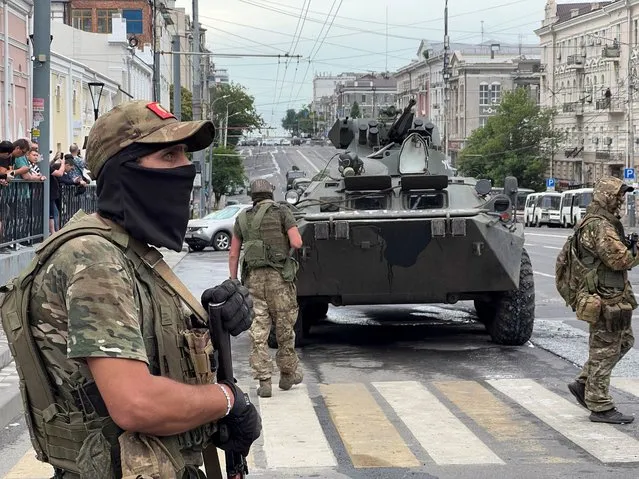 Fighters of Wagner private mercenary group stand guard in a street near the headquarters of the Southern Military District in the city of Rostov-on-Don, Russia on June 24, 2023. (Photo by Reuters/Stringer)