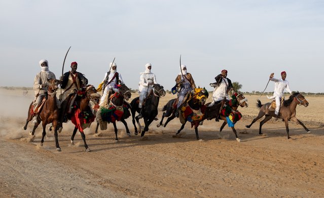 Riders and their horses perform a fantasia during the second edition of the Grand Prix Apec (Association des professionnels des établissements de crédit) at the opening of the AEARCT (Association d'encouragement pour l'amélioration des races des chevaux du Tchad) horse racing season in N'Djamena province, at the Ouka-Djermaya racecourse, on January 4, 2025. (Photo by Joris Bolomey/AFP Photo)