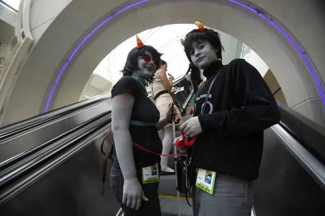 Attendees Delaney Oldenburg (L) and Sabrina Zaitz, who are wearing costumes inspired by the webcomic Homestuck, ride an escalator during Comic-Con international convention in San Diego, California July 13, 2012. (Photo by Mario Anzuoni/Reuters)