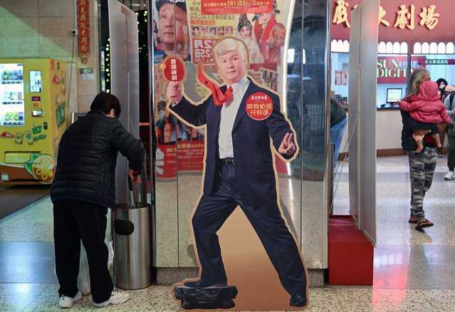 This photo taken on January 31, 2025 shows a promotional cutout of Hong Kong actor Loong Koon-tin as US President Donald Trump in the satirical play “Trump, the Twins President” which was performed in the Sunbeam Theatre in Hong Kong on February 1-3. The sold-out show, which runs for nearly four hours, begins with Richard Nixon's meeting with Mao Zedong in 1972 then spirals into a tale about Trump searching for his lost Chinese twin, with North Korean leader Kim Jong Un making an appearance. (Photo by Peter Parks/AFP Photo)