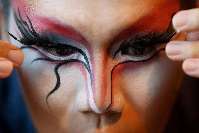 Drag performer Yeo Sam Jo, 35, whose stage name is JoJo Sam Clair, puts on fake eyelashes before a performance at a local club in Singapore on June 15, 2023. (Photo by Edgar Su/Reuters)