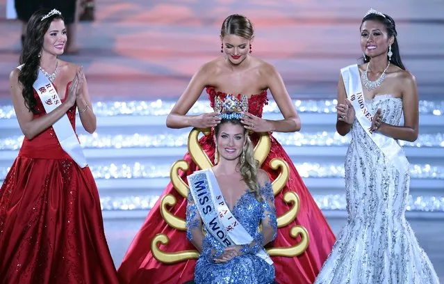 Mireia Lalaguna Rozo (C) of Spain is crowned by former Miss World Jolene Strauss after winning the new title at the Miss World Grand Final in Sanya, next to Miss Russia, Sofia Nikitchuk (L) and Miss World Indonesia, Maria Harfanti (R) in southern China's Hainan province on December 19, 2015. (Photo by Johannes Eisele/AFP Photo)